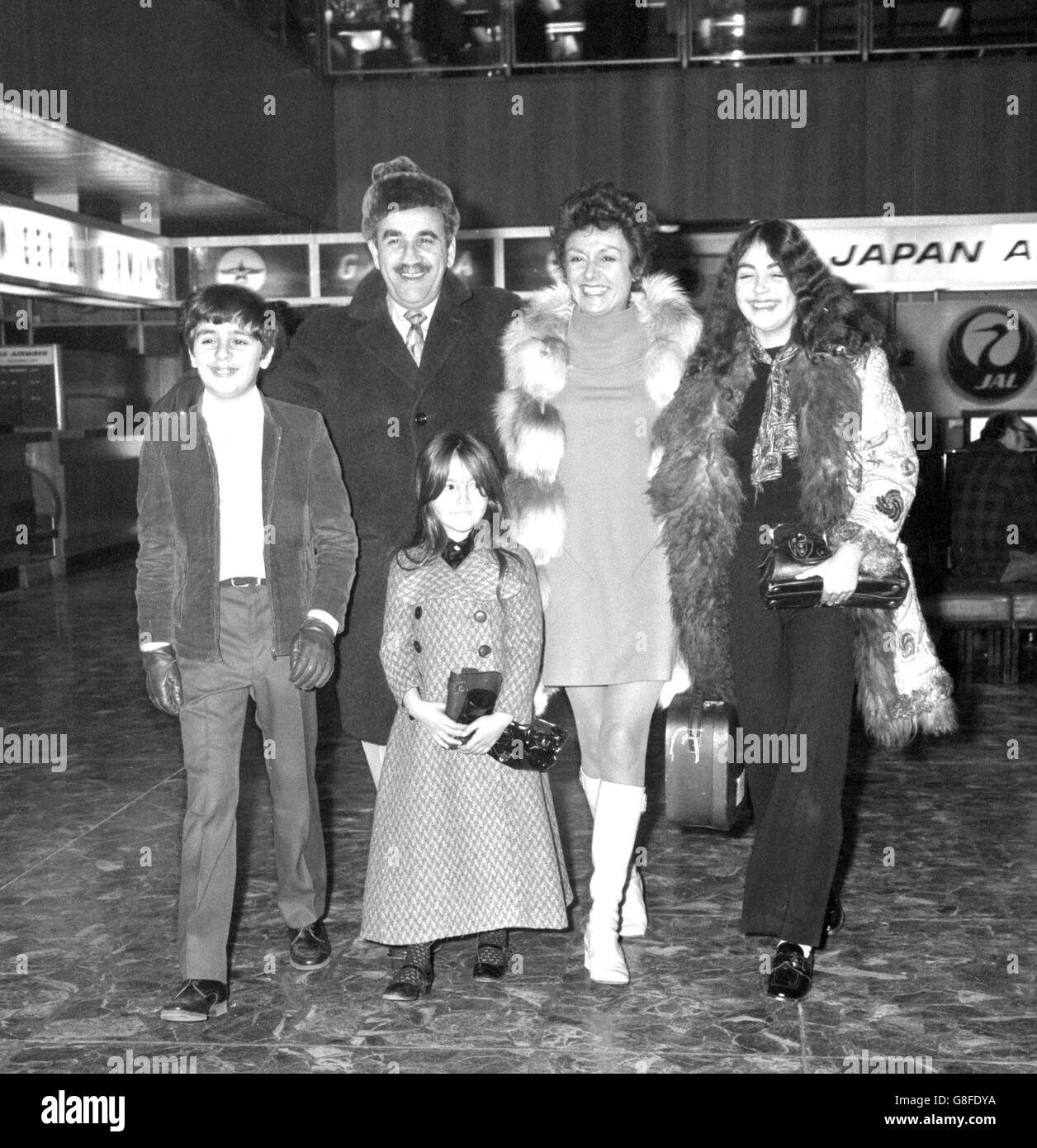 Off to spend Christmas in Fiji are actor Warren Mitchell, his wife Constance Wake, and their three children Rebecca, 14, Daniel, 12, and Anna, 6. They were flying from Heathrow Airport, London. After Fiji, Mr Mitchell, who was TV's Alf Garnett, will go to Australia to play the top spot in cabaret at the Hilton Hotel in Melbourne. Stock Photo