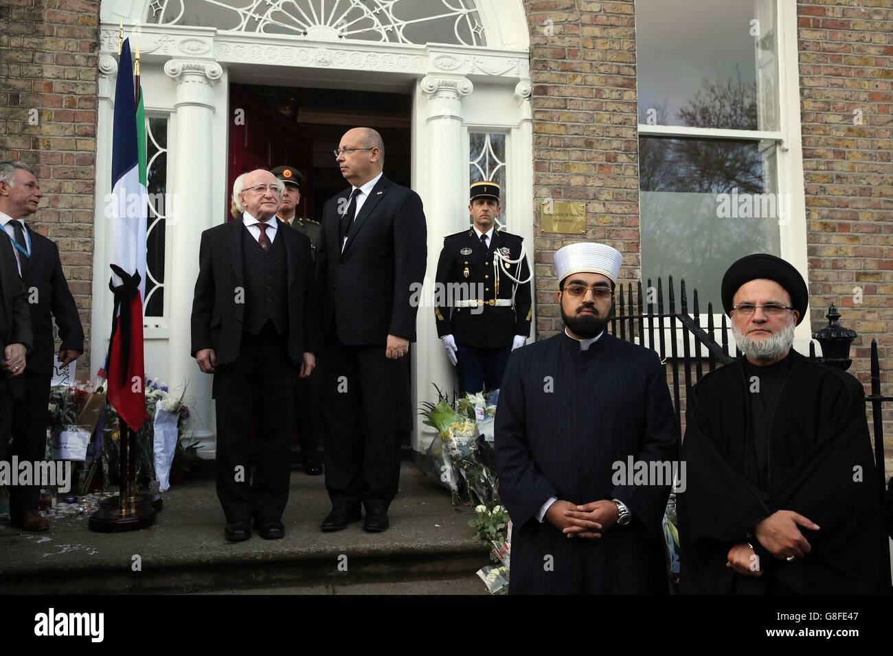 (From the left) President of Ireland Michael D. Higgins, French Ambassador to Ireland Jean Pierre Thebault Shaykh Muhammad Umar Al-Qadri and Imam of Miltown Mosque Ali Al Saleh outside the French Embassy in Dublin ahead of a minute's silence across Europe to mark the victims of Friday's attacks in the French capital. Stock Photo