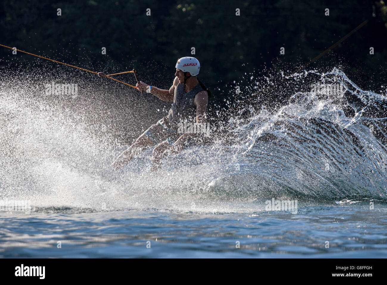 Wakeboarding on cable big splash after jump Stock Photo Alamy