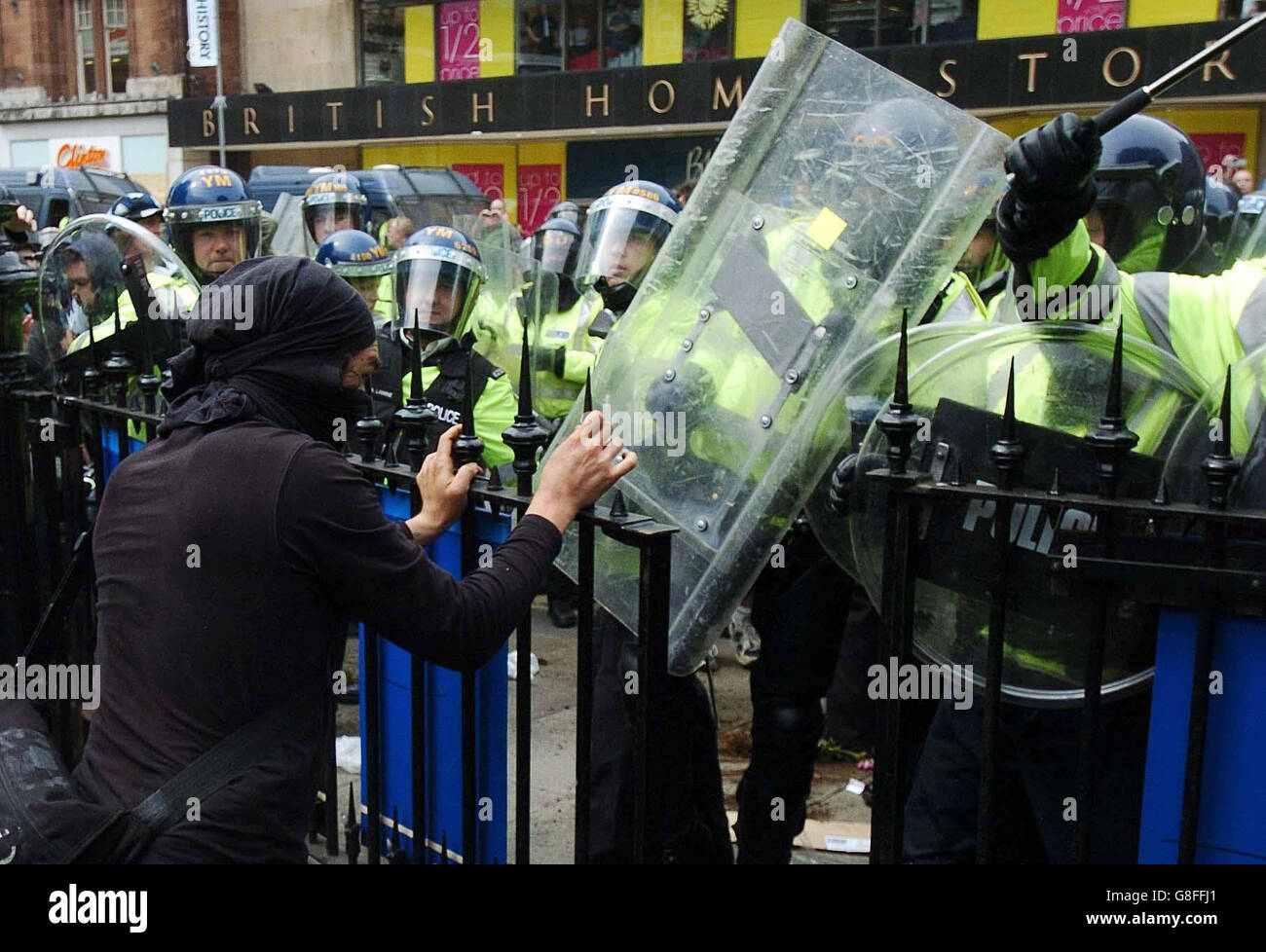 Riot police in Edinburgh charge a crowd of protestors with shields and batons, as anti-capitalist demonstrators took to the streets of Scotland's capital ahead of Wednesday's meeting of the G8 leaders in Gleneagles. Stock Photo