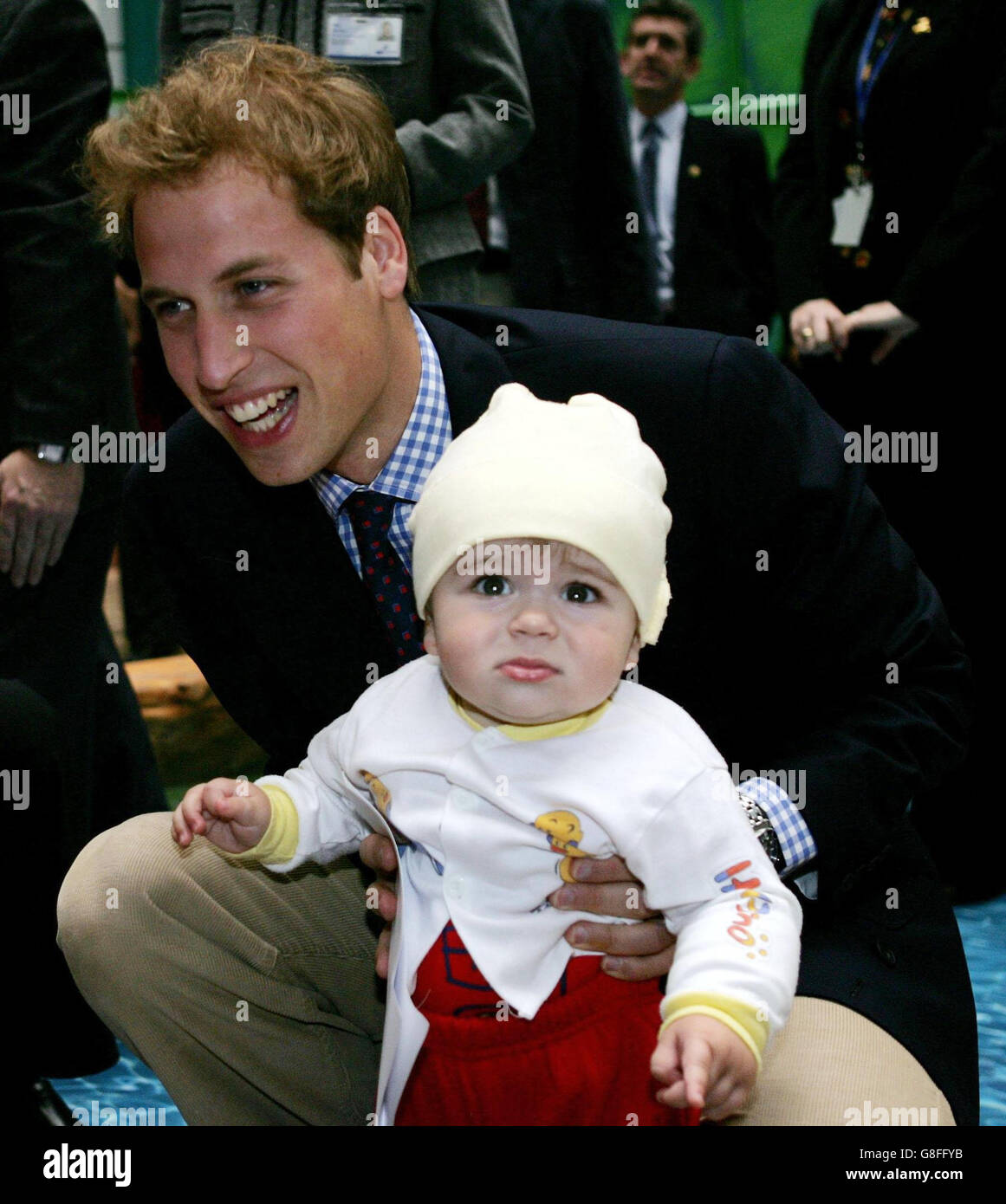 Prince William holds one-year-old Kennard Nanau during a visit to Auckland's Starship Childrens Hospital. Stock Photo