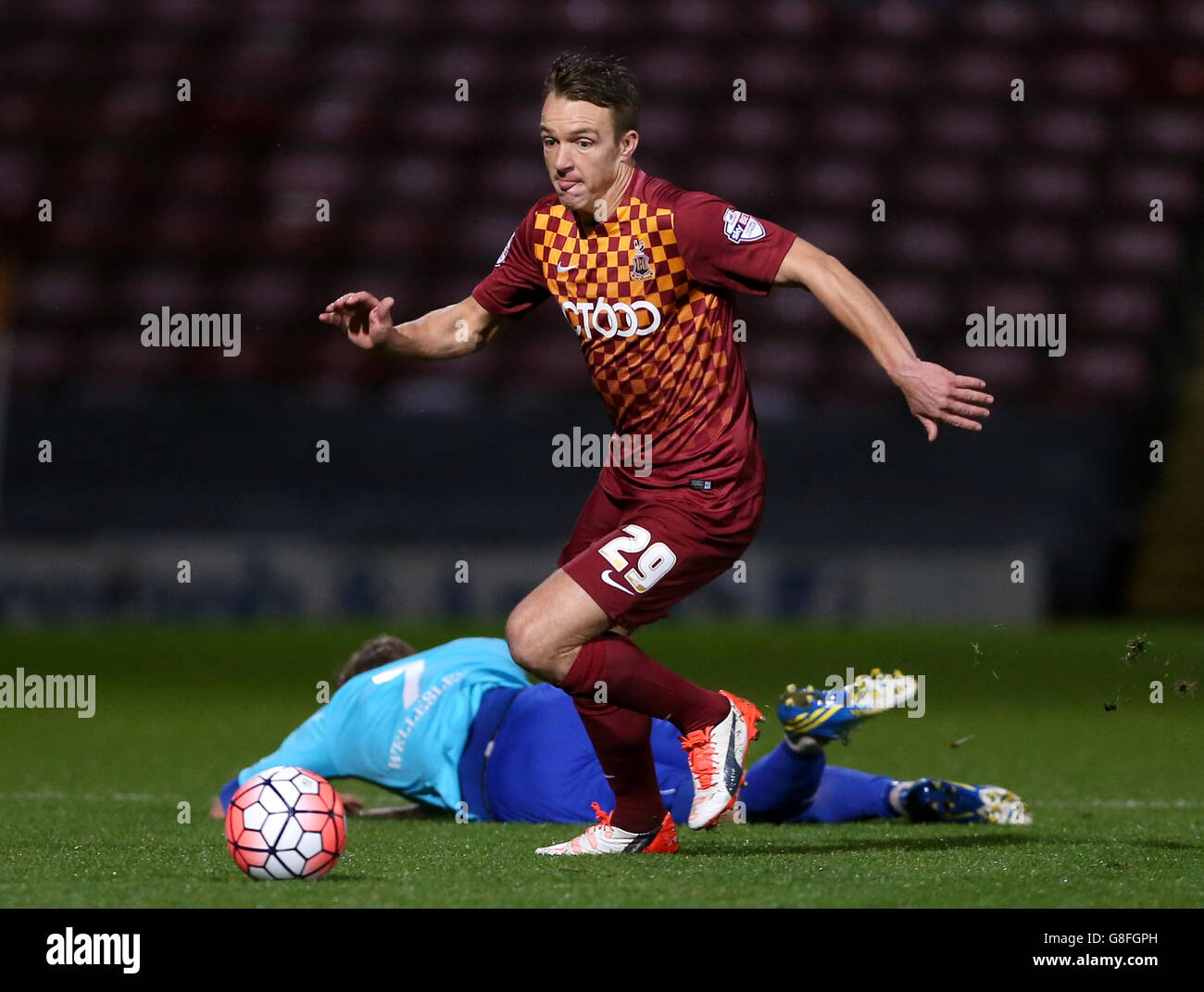 Bradford City's Tony McMahon tackles Aldershot Town's Sam Hatton during the Emirates FA Cup first round replay match at Valley Parade, Bradford. Stock Photo