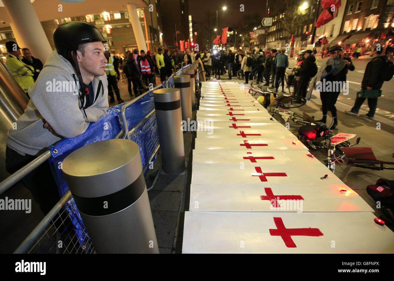 Protesters gather around mock coffins during a 'die in' rally outside Transport for London's (TfL) headquarters on Blackfriars Road in London, in a call for it to spend more money on cycling infrastructure in the capital. Stock Photo