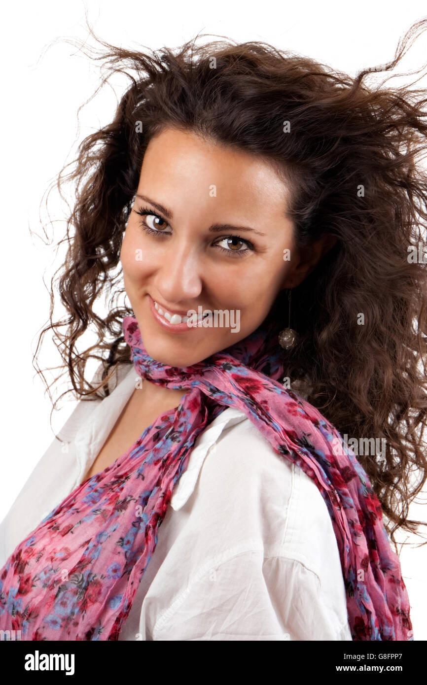 Cheerful young woman smiling with pink scarf and white background. Stock Photo