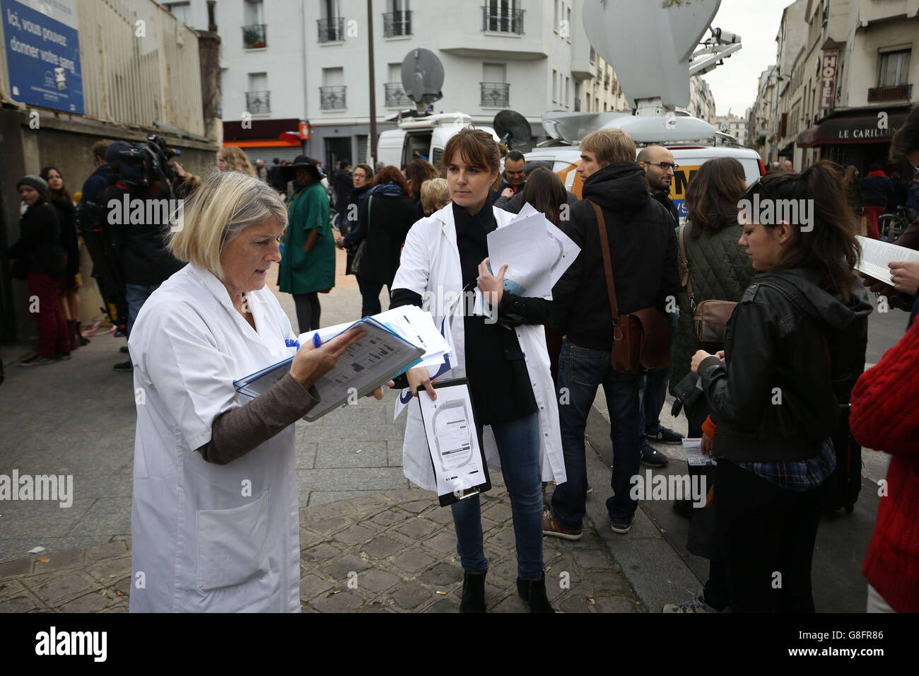 People queue to give blood at a makeshift centre near to the Le Petit Cambodge, Paris, one of the venues for the attacks in the French capital which are feared to have killed around 127 people. Stock Photo