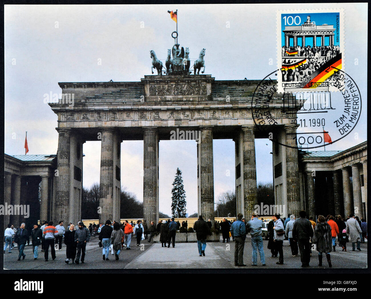 GERMANY - CIRCA 1990: A postcard printed in Germany commemorates the fall of the Berlin Wall on November 9, 1989, shows brandenb Stock Photo