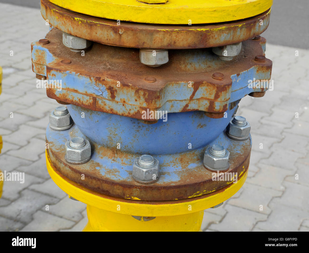 Large bolts and nut holding pipe together, Romania June 2016 Stock Photo