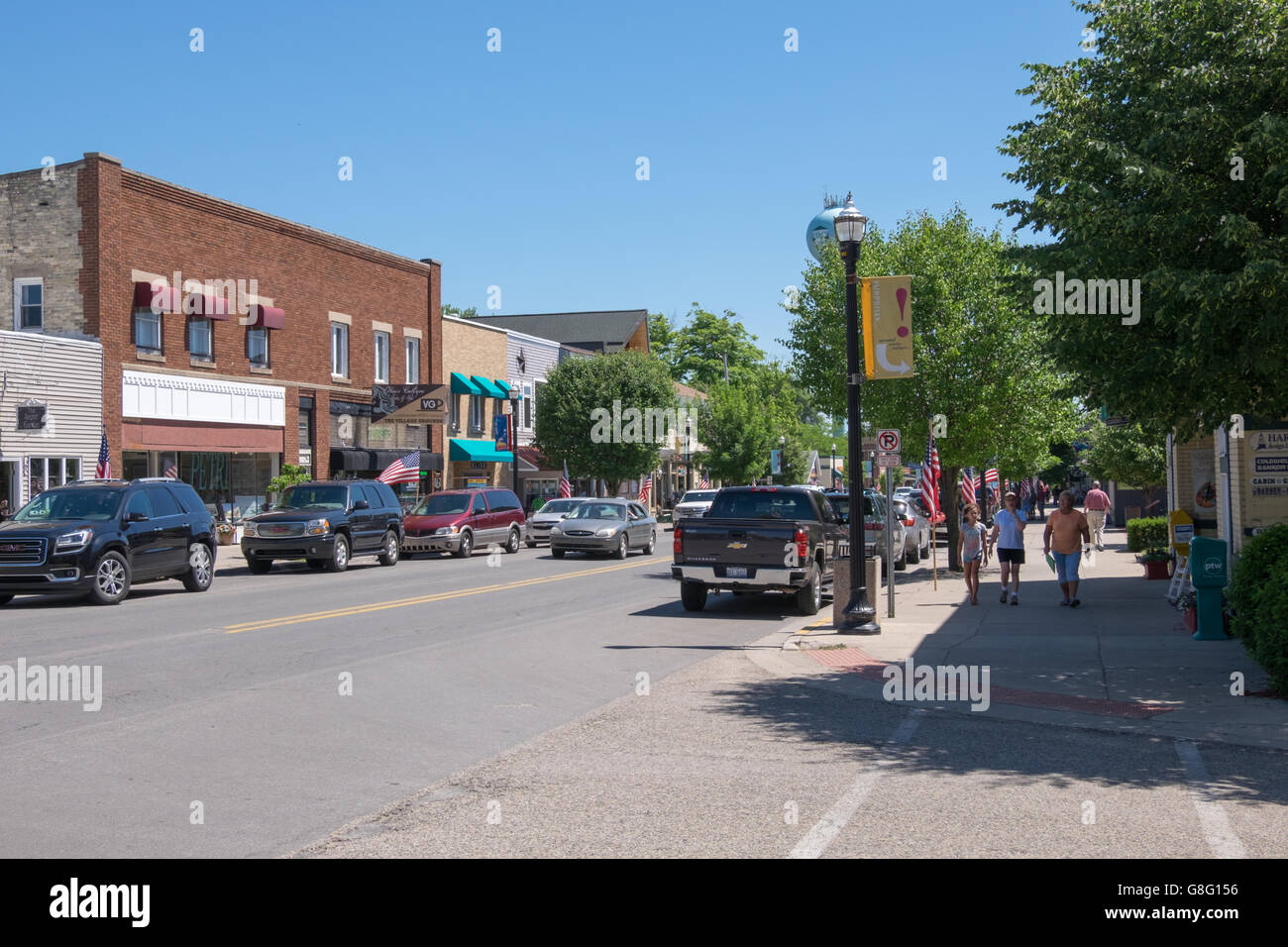 sidewalks and shops in downtown Pentwater, Michigan on a bright summer