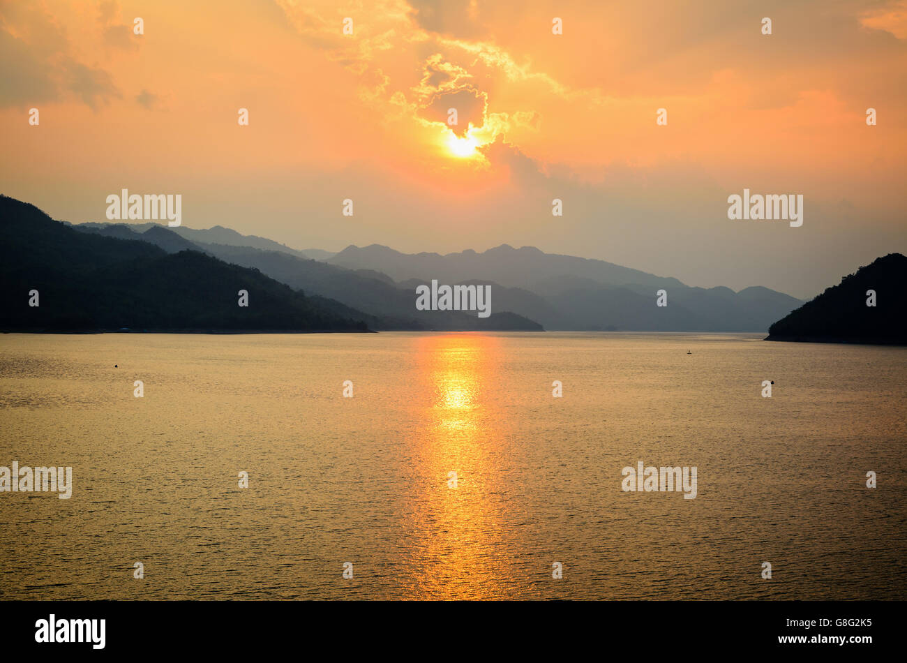 Beautiful landscape during sunset over a mountain ranges at lake in Srinakarin Dam, Kanchanaburi Province, Thailand Stock Photo