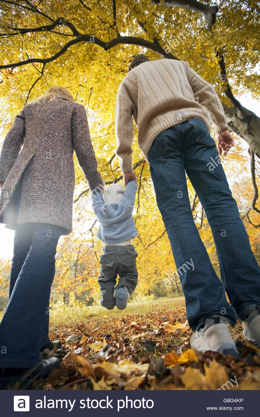 Parents Swinging Child Between Them Stock Photos & Parents Swinging