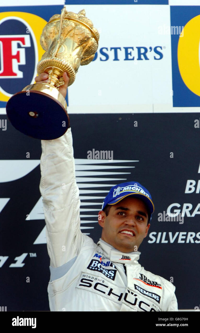 Colombia's and McLaren Mercedes driver Juan Pablo Montoya celebrates with his trophy on the podium after winning the British Grand Prix. Stock Photo