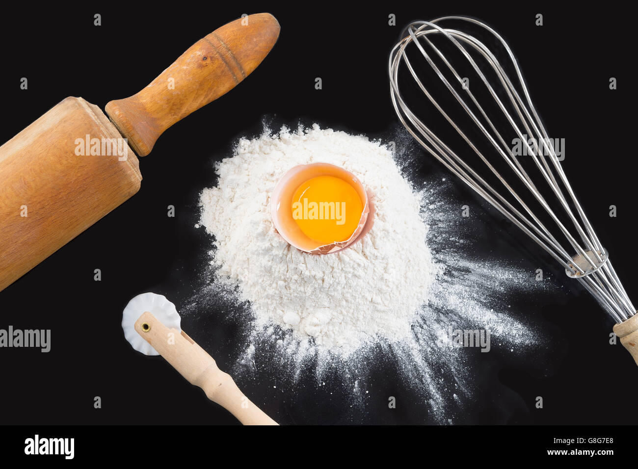 whisk and ingredients on a black background Stock Photo Alamy