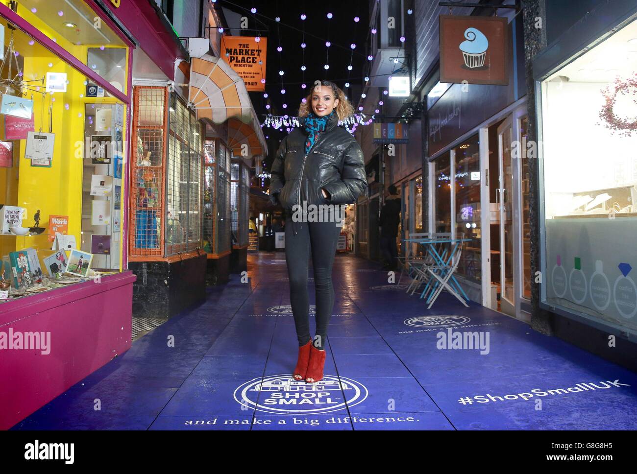 Alesha Dixon, Amex Shop Small Ambassador shows off her pavement power to encourage people to shop small this Christmas. The energy from her footsteps on a power-generating pavement installed by American Express lights up 400 Christmas lights along Meeting House Lane. Stock Photo