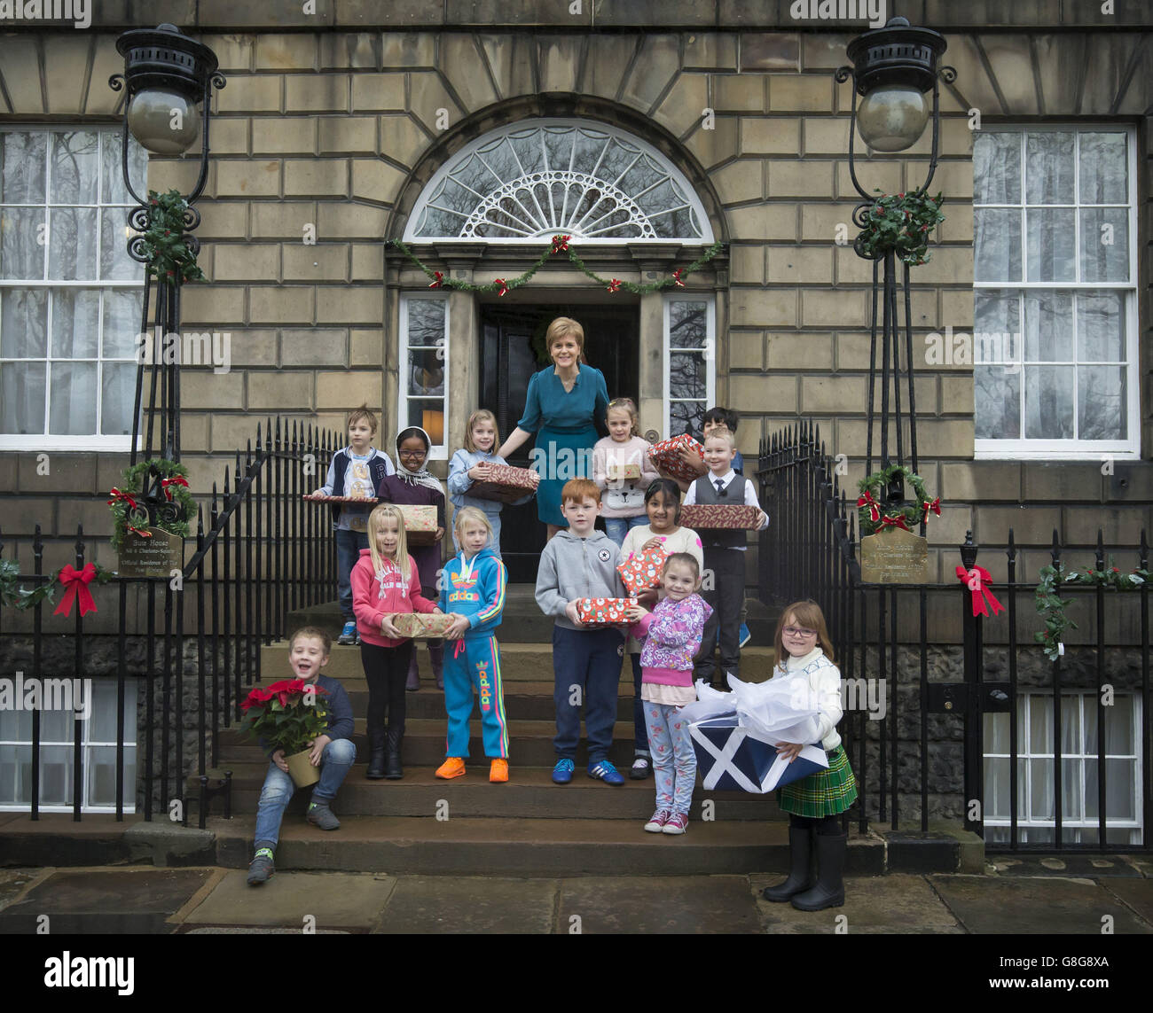 Scottish First Minister Nicola Sturgeon with schoolchildren from Forthview Primary School in Pilton as she unveils her 2015 Christmas card at her official residence in Edinburgh, Bute House. A special festive illustration of Katie Morag by Mairi Hedderwick features on the front of the card. Stock Photo