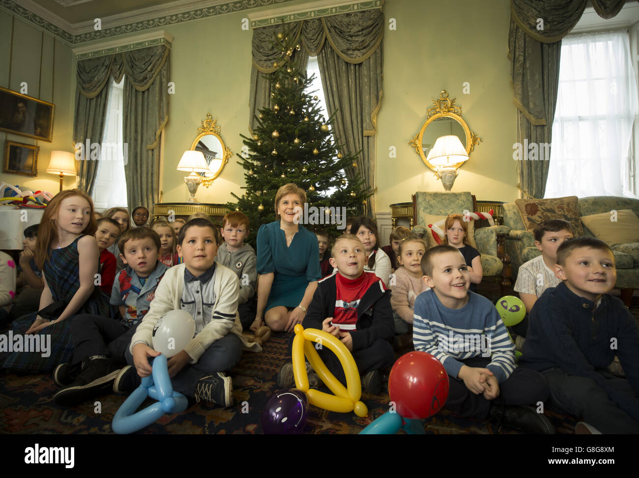 Scottish First Minister Nicola Sturgeon with schoolchildren from Forthview Primary School in Pilton as she unveils her 2015 Christmas card at her official residence in Edinburgh, Bute House. A special festive illustration of Katie Morag by Mairi Hedderwick features on the front of the card. Stock Photo