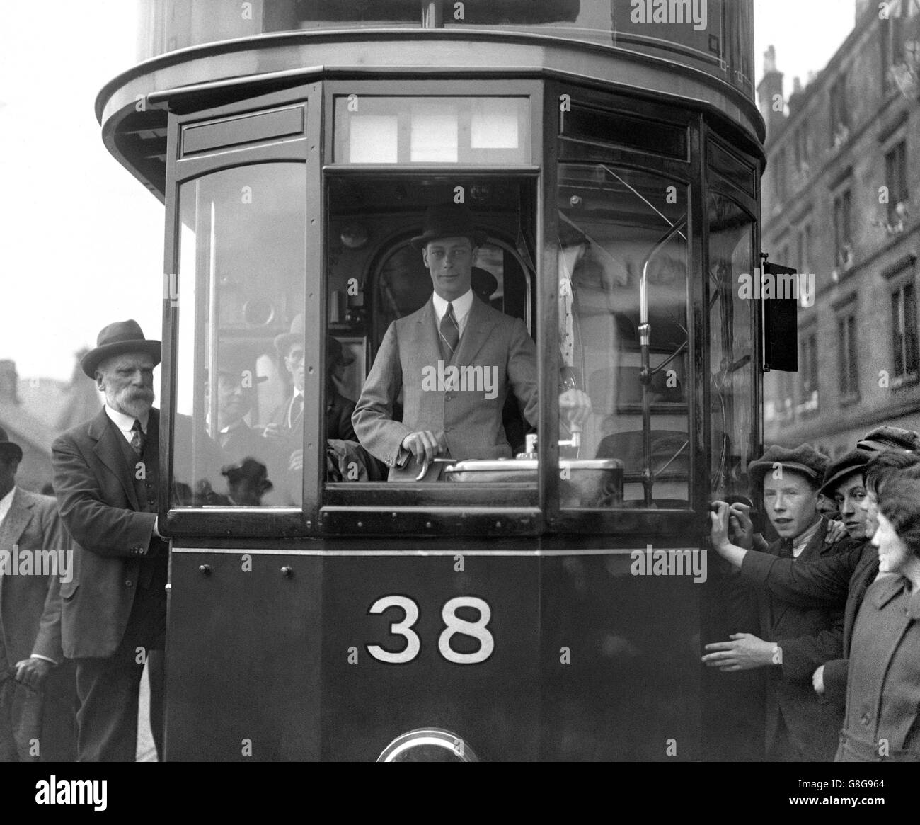 The Duke of York drives a tram to the depot through crowded streets after the opening of the new recreation ground of the Corporation Tramway Department in Glasgow. Stock Photo