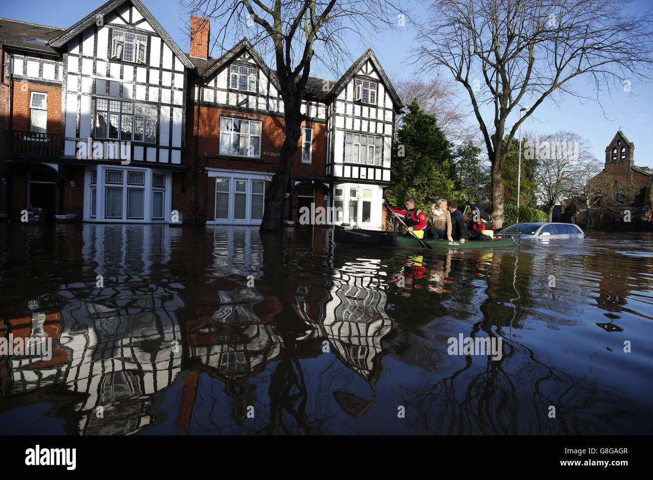 A boat rows down Warwick Road, following flooding in the town of Carlisle. Stock Photo