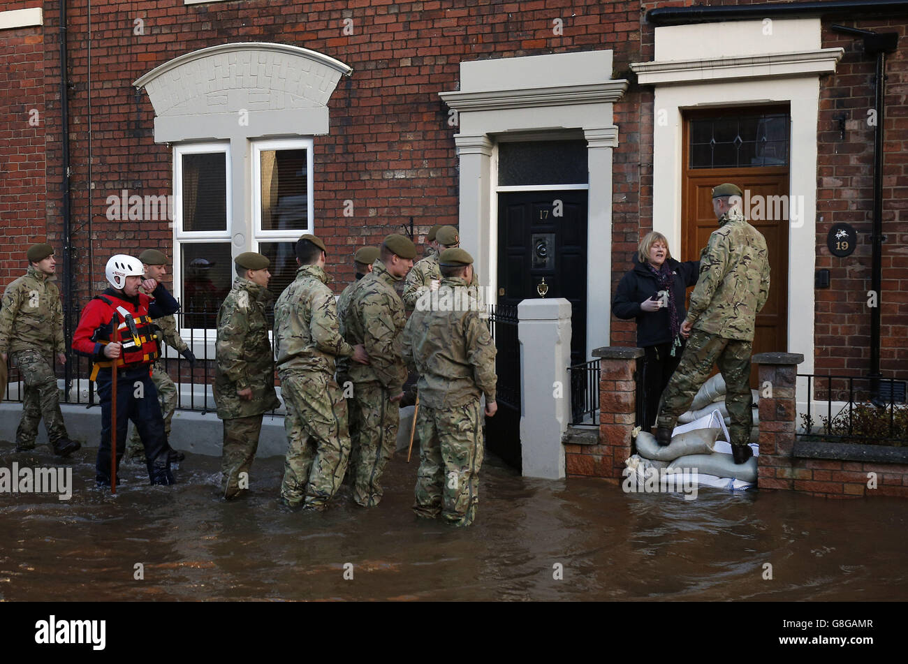 Member of the armed forces check on residents on Lismore Street