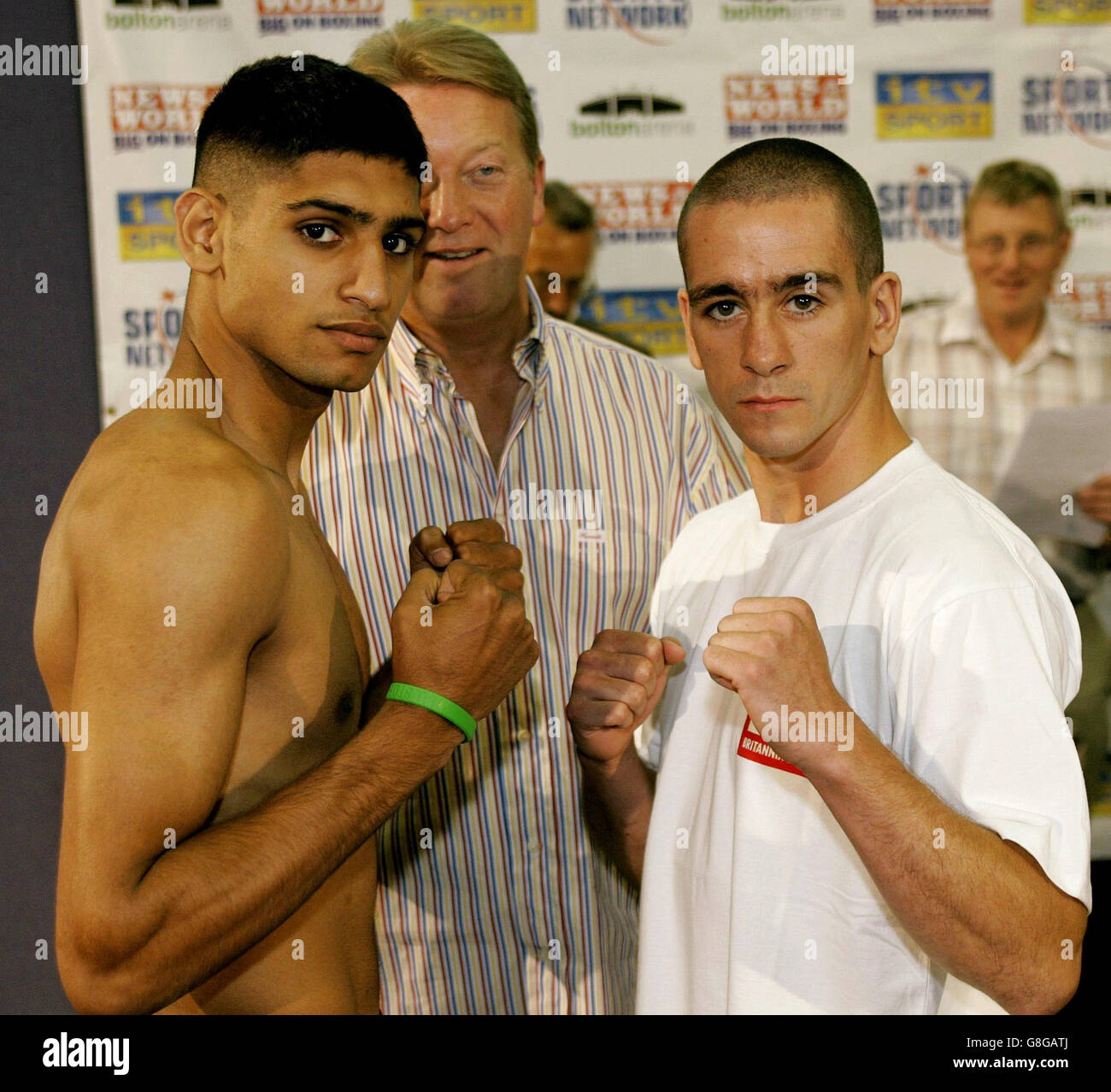 Great Britain's Olympic silver medalist Amir Khan (L) with opponent 