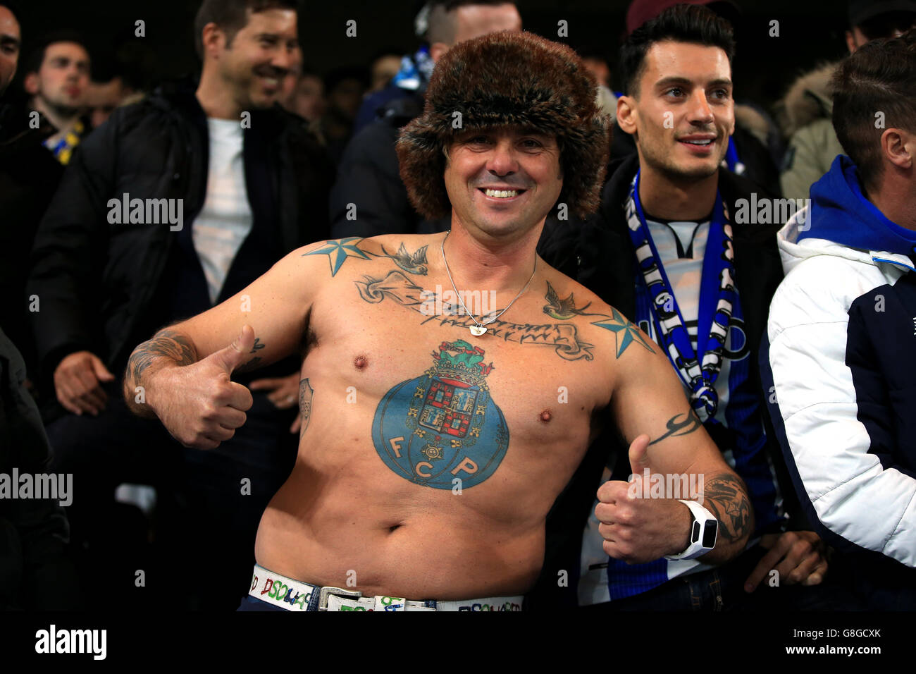 A Porto fan with the club badge tattooed on his stomach during the UEFA Champions League match at Stamford Bridge, London. Stock Photo