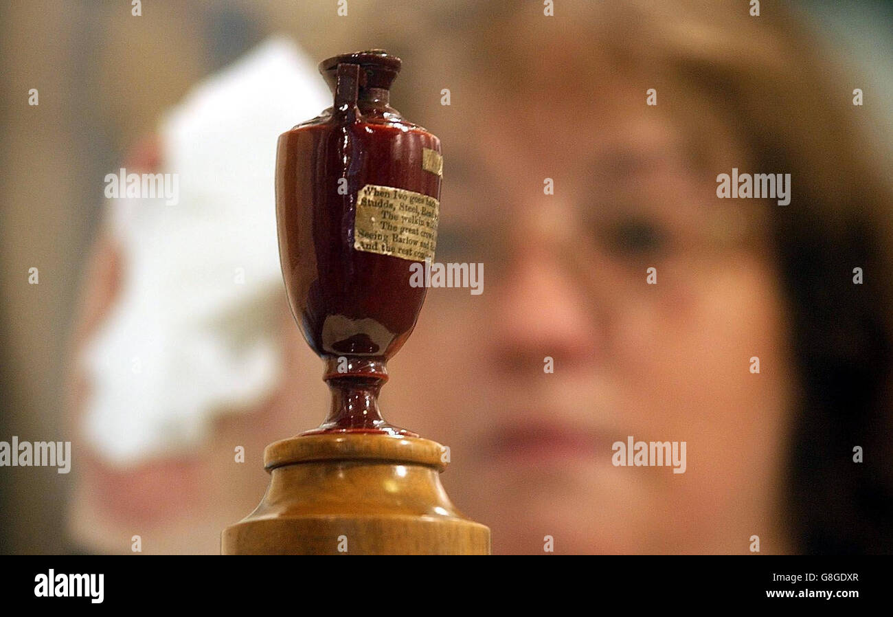 Glenys Williams, deputy curator, cleans the glass case which displays the Ashes urn in the museum at Lords Cricket Ground, St John's Wood. The ashes urn has been a feature at the Lord's museum since it was presented by Lord Darnley's Australian-born widow, Florence. Stock Photo