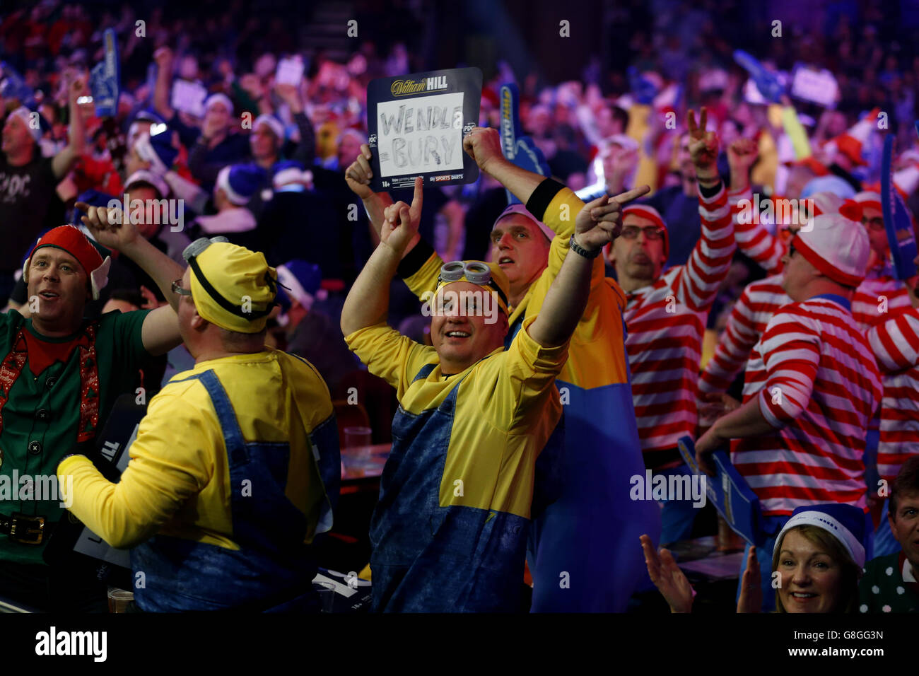 A general view of fans in fancy dress during day two of the William Hill PDC World Championship at Alexandra Palace, London. Stock Photo