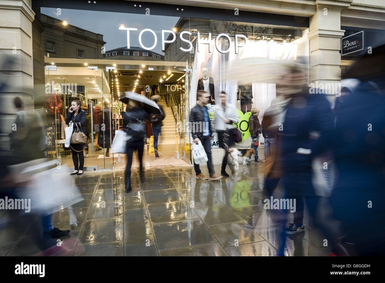 Shoppers at Topshop in Bath, as panic-buyers and bargain-hunters are expected to flood stores on the busiest day in the Christmas shopping calendar today, with high street shops slashing prices in an attempt to coax consumers down the aisles. Stock Photo