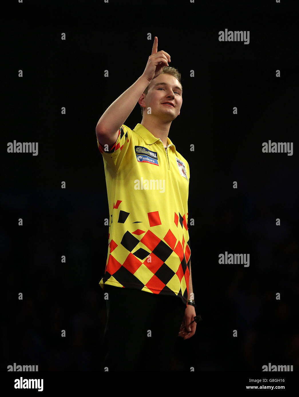 Dimitri Van den Bergh celebrates winning the first round match during