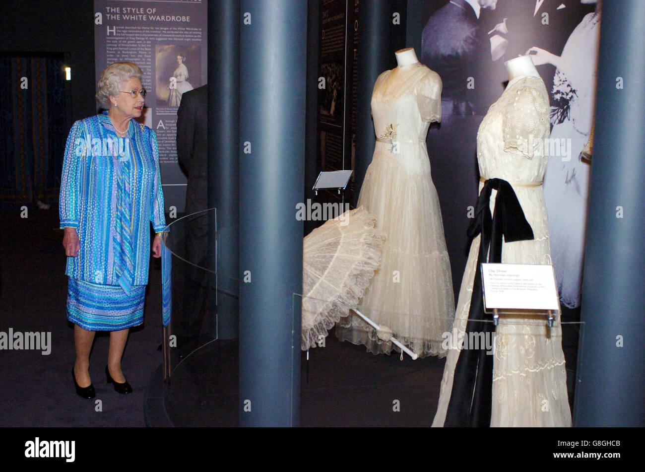 Britain's Queen Elizabeth II looks at her mother, Queen Elizabeth's 'White Wardrobe' which forms part of the special exhibition for the summer opening of Buckingham Palace, inside the Palace in central London. The exhibition will open to the public this Saturday on July 30. Stock Photo
