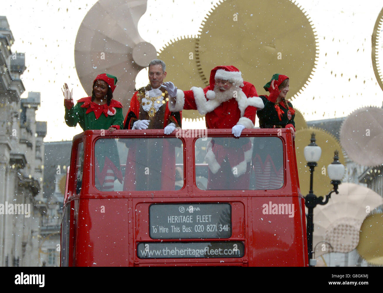 Father Christmas and the Lord Mayor ride a double decker bus during