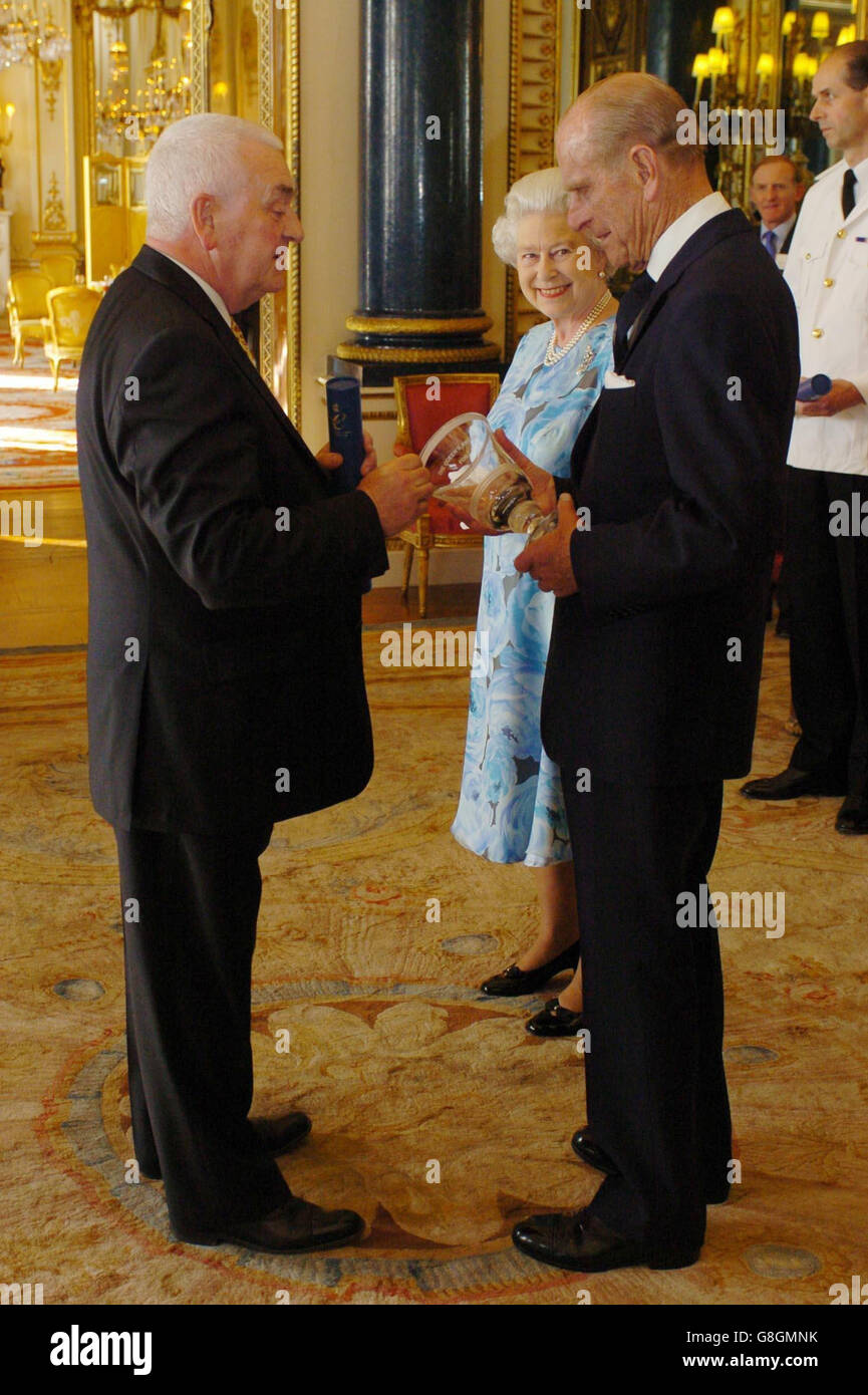 Britain's Queen Elizabeth II and the Duke of Edinburgh present Professor Alan Barrell FRSA, a Cambridge-based businessman, with the Queen's Award for Enterprise Promotion inside The White Room at Buckingham Palace. Stock Photo