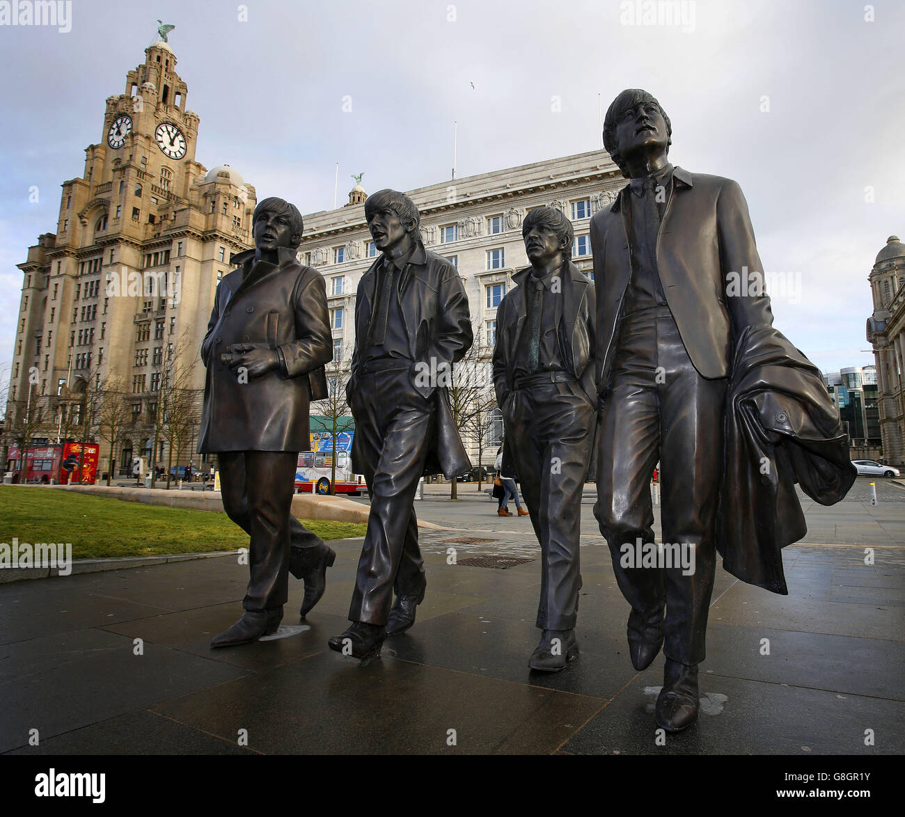 A new statue of the Beatles is unveiled by John Lennon's sister Julia Baird (not pictured) outside the Liverbuilding, in Liverpool. Stock Photo