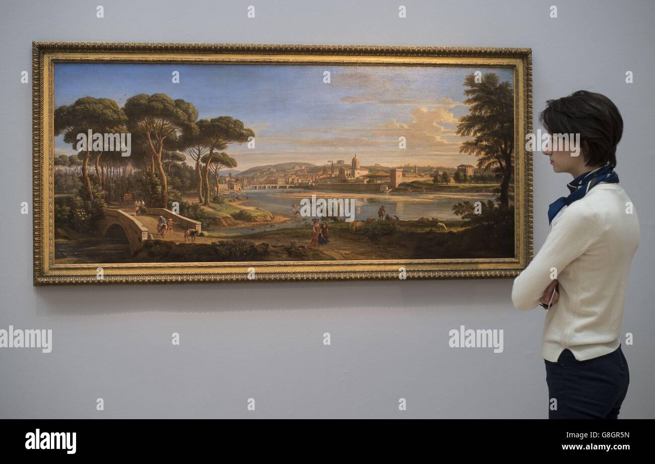 A member of staff views 'Florence, A View of The City from the right bank of the River Arno looking towards the Ponte Alla Carraia' by Gaspar van Wittel or Vanvitelli, estimated at £1,000,000 to £1,500,000, during a press preview for highlights of Sotheby's forthcoming sale of Old Master and British Paintings due to take place on December 9 in London. Stock Photo