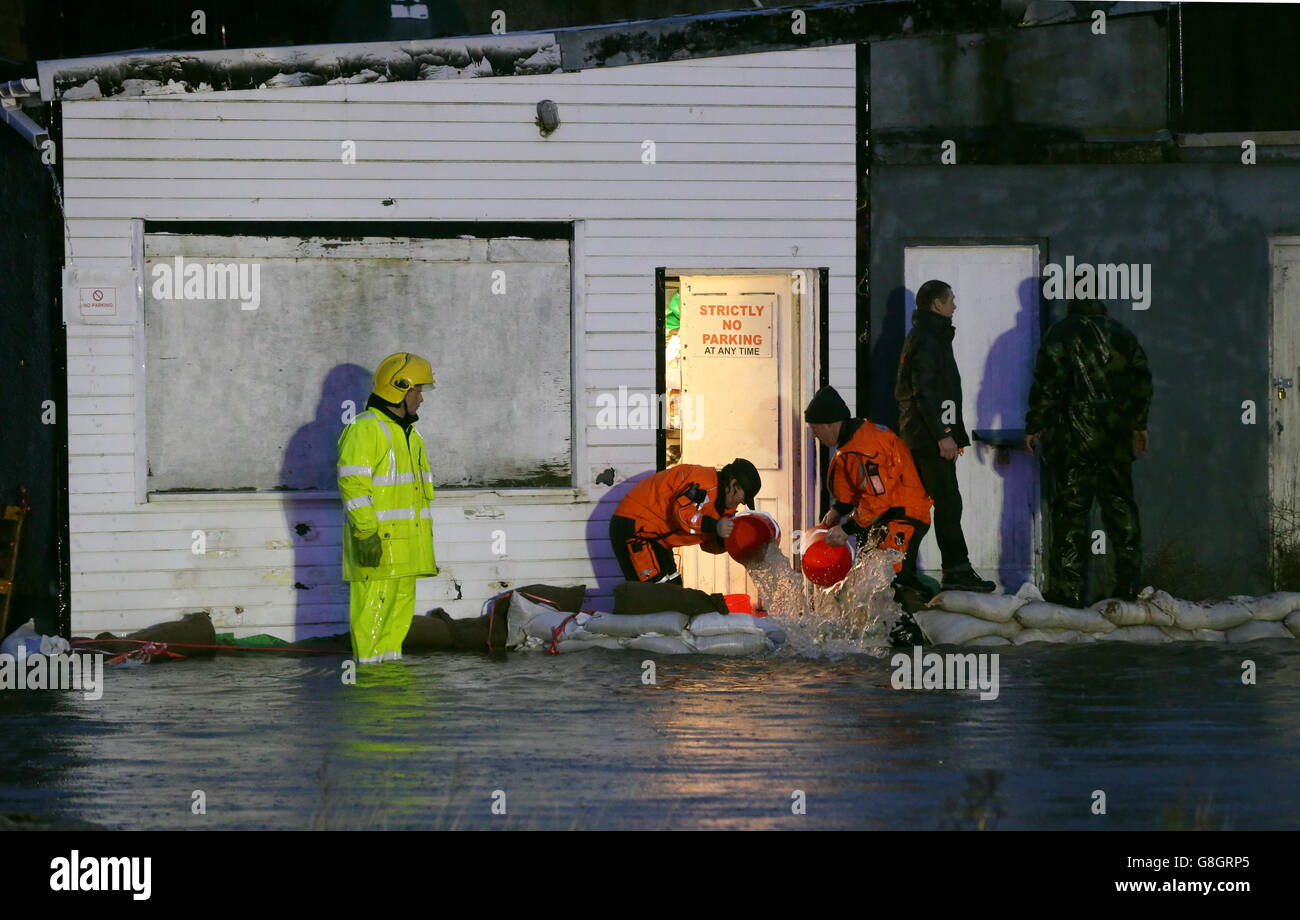 Members of the fire service and the army bail out water from shops in the Ballybofey area of Donegal. Stock Photo