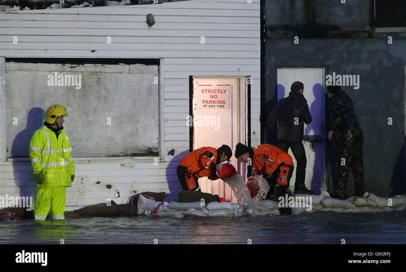 Members of the fire service and the army bail out water from shops in the Ballybofey area of Donegal. Stock Photo