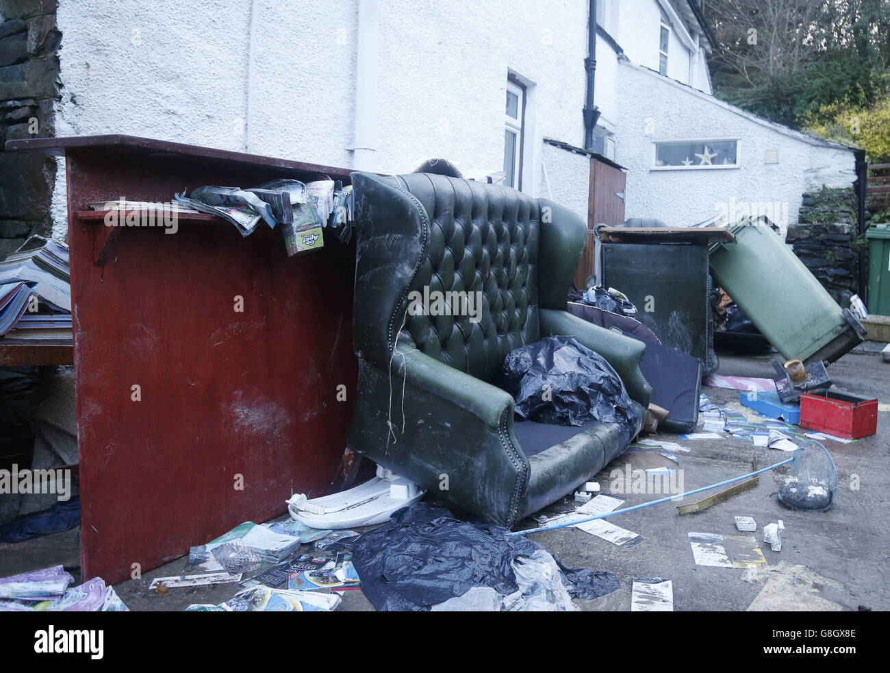 Flood damage items in the street in Glenridding after the river in the town in Cumbria burst its banks again following continued rainfall last night. Stock Photo