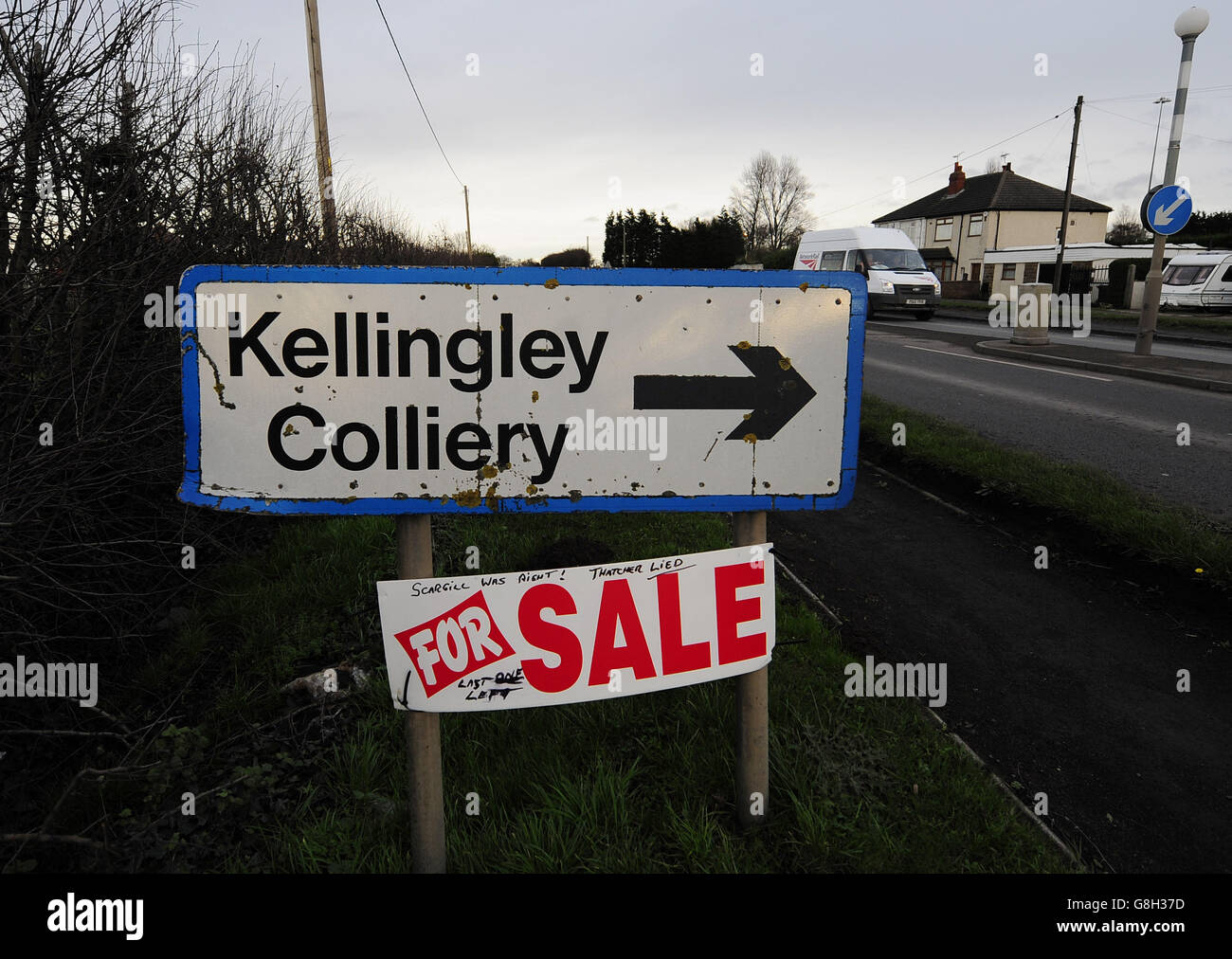A 'For Sale' notice that was placed beneath a sign for Kellingley Colliery on the final day of production at the pit in Knottingley, North Yorkshire. Stock Photo