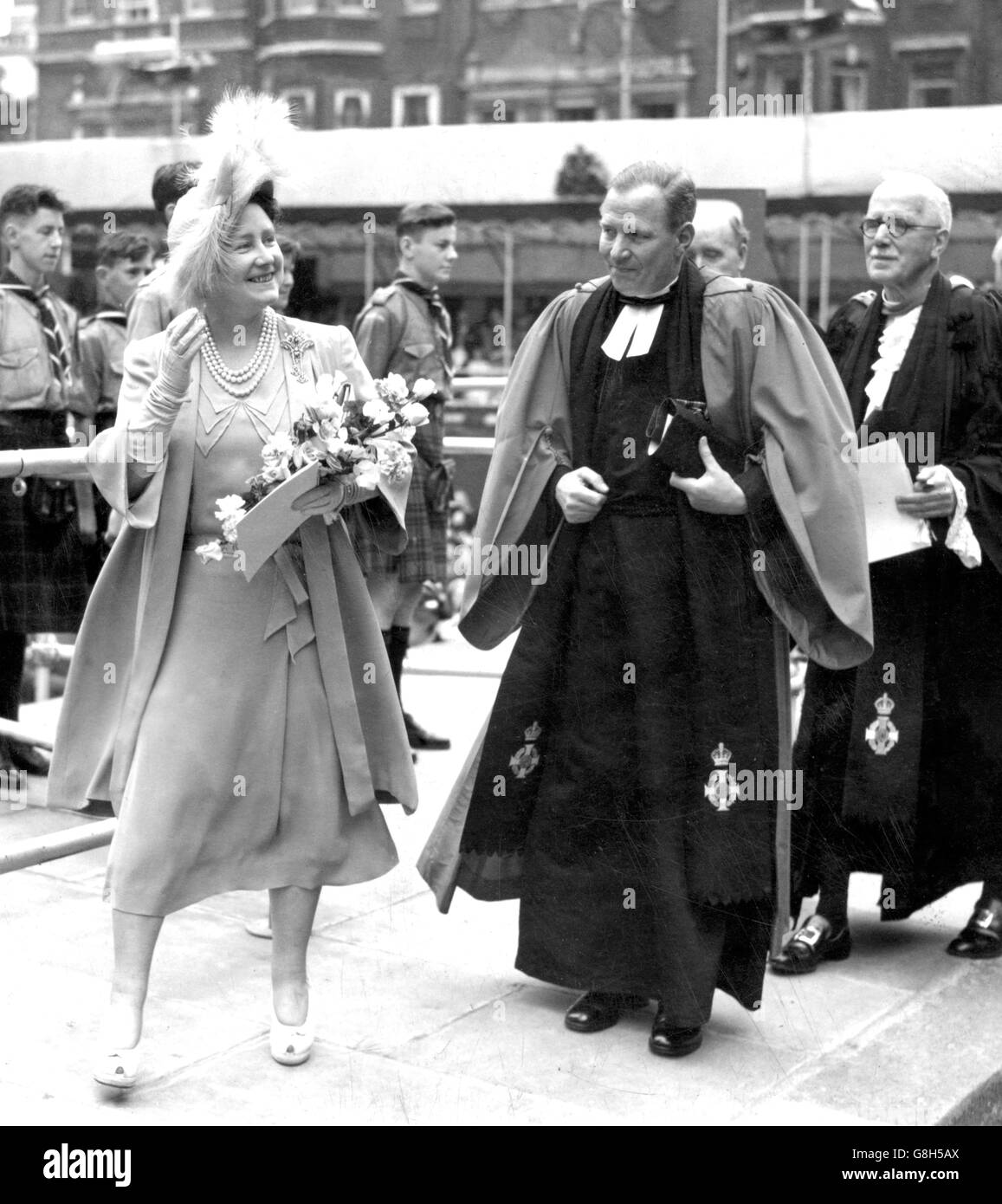 Queen Elizabeth, the Queen Consort, with Dr RFV Scott, Minister at St Columba's Church of Scotland since 1941, on the site of the new church in Pont Street, where she was laying the foundation stone. The new church to rise on this site replaces the original at St Columba's, principal place of worship for Scots in London, which was destroyed in the blitz of May 1941. Stock Photo