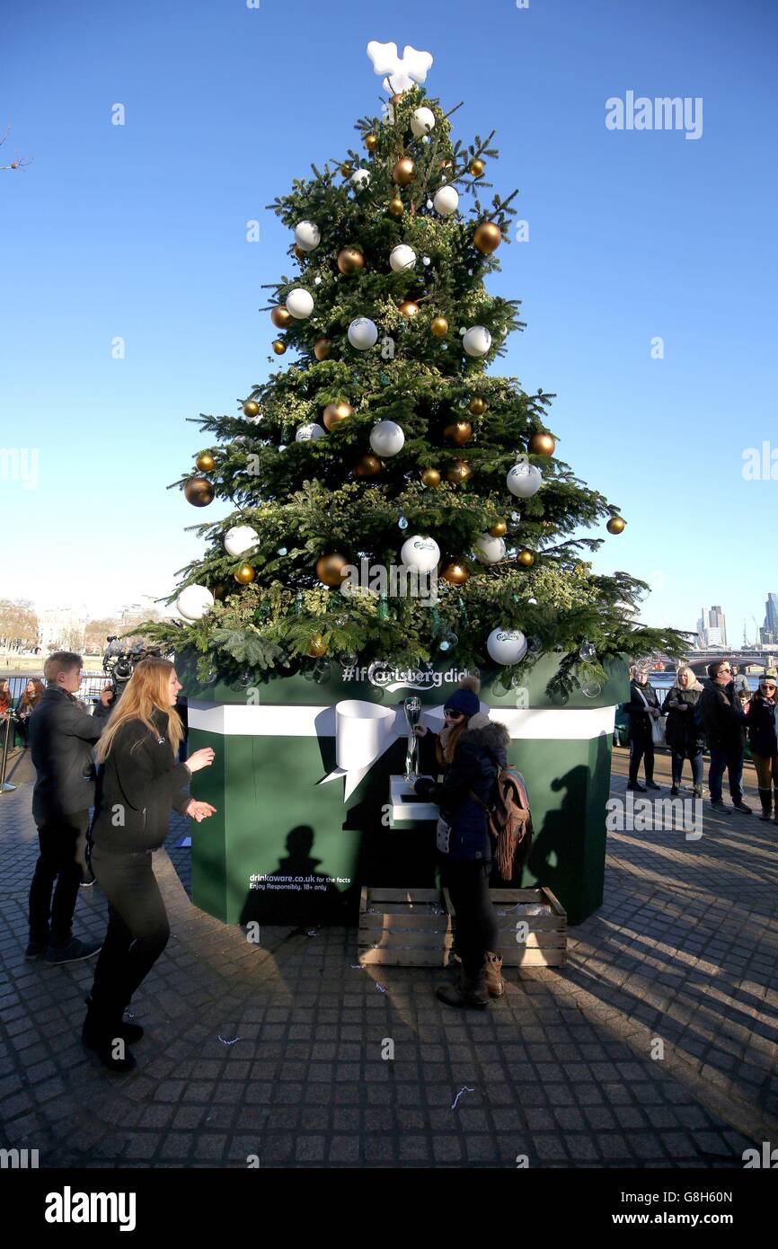 A 27ft real fir Christmas tree complete with a beer-dispensing pump which was launched by Carlsberg on The Southbank, London. Stock Photo