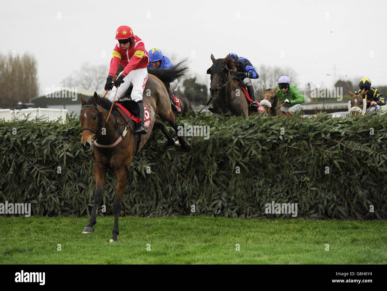 Highland Lodge and Henry Brooke jump the final fence as they win the Betfred Becher Chase during the Betfred Becher Chase Community Day at Aintree Racecourse. Stock Photo