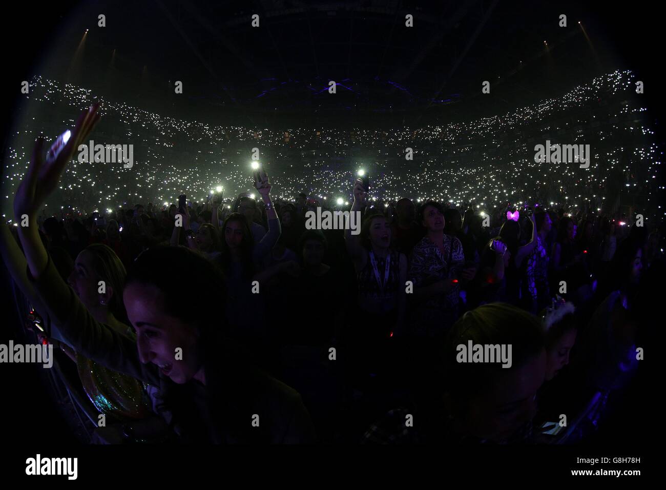 The crowd use their mobile phones as torches as Calvin Harris performs on  stage during the Capital FM Jingle Bell Ball 2015 held at The O2 Arena,  London Stock Photo - Alamy