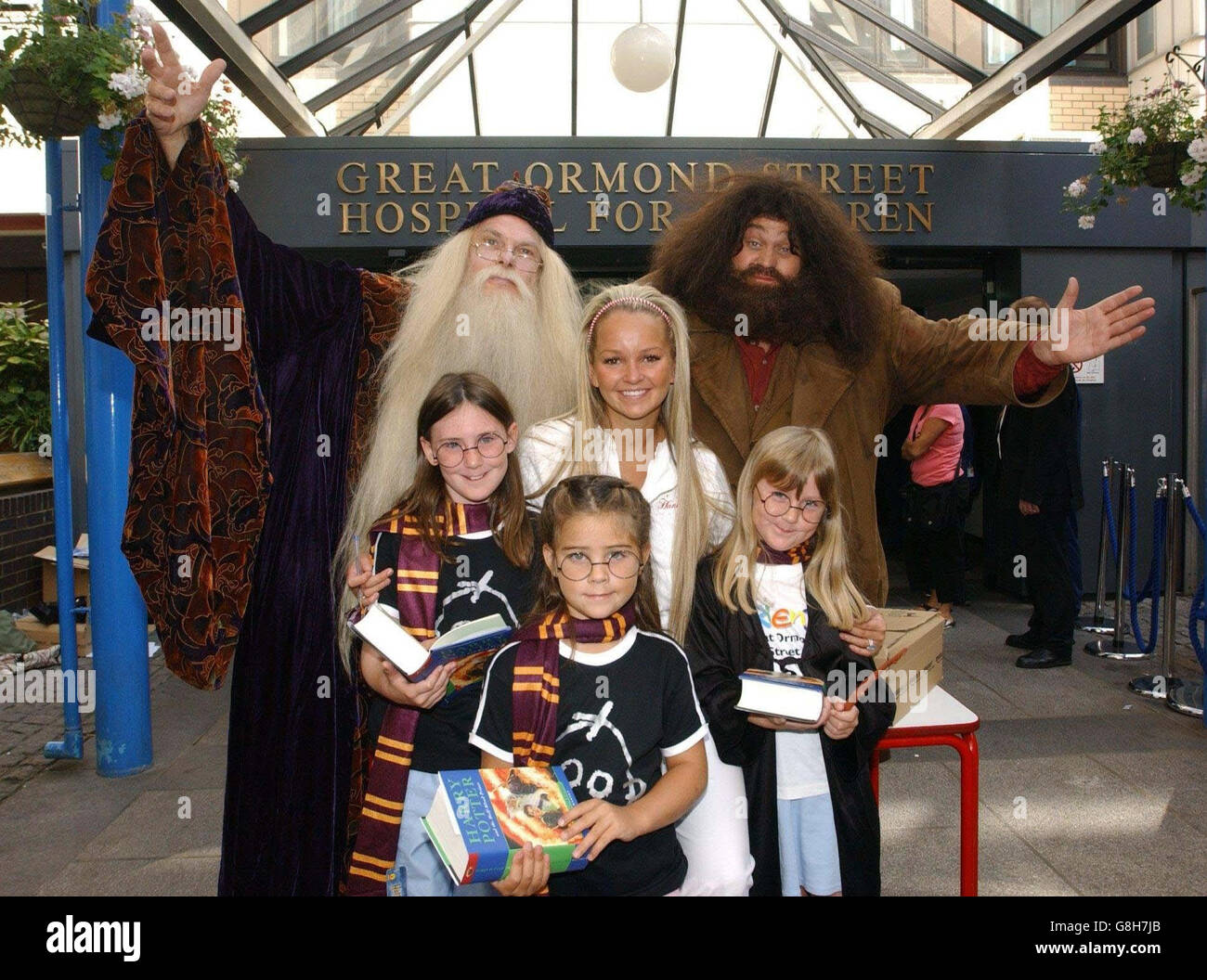 Jennifer Ellison, Hagrid and Professor Dumbledore with children (from left to right) Charlotte Horn, aged 11 rfom Luton, Bethany Evans, aged 6 from Swansea, and Bethany Horn, aged 8 from Luton during a visit to hand out copies of the new Harry Potter book, which was released at midnight. Stock Photo
