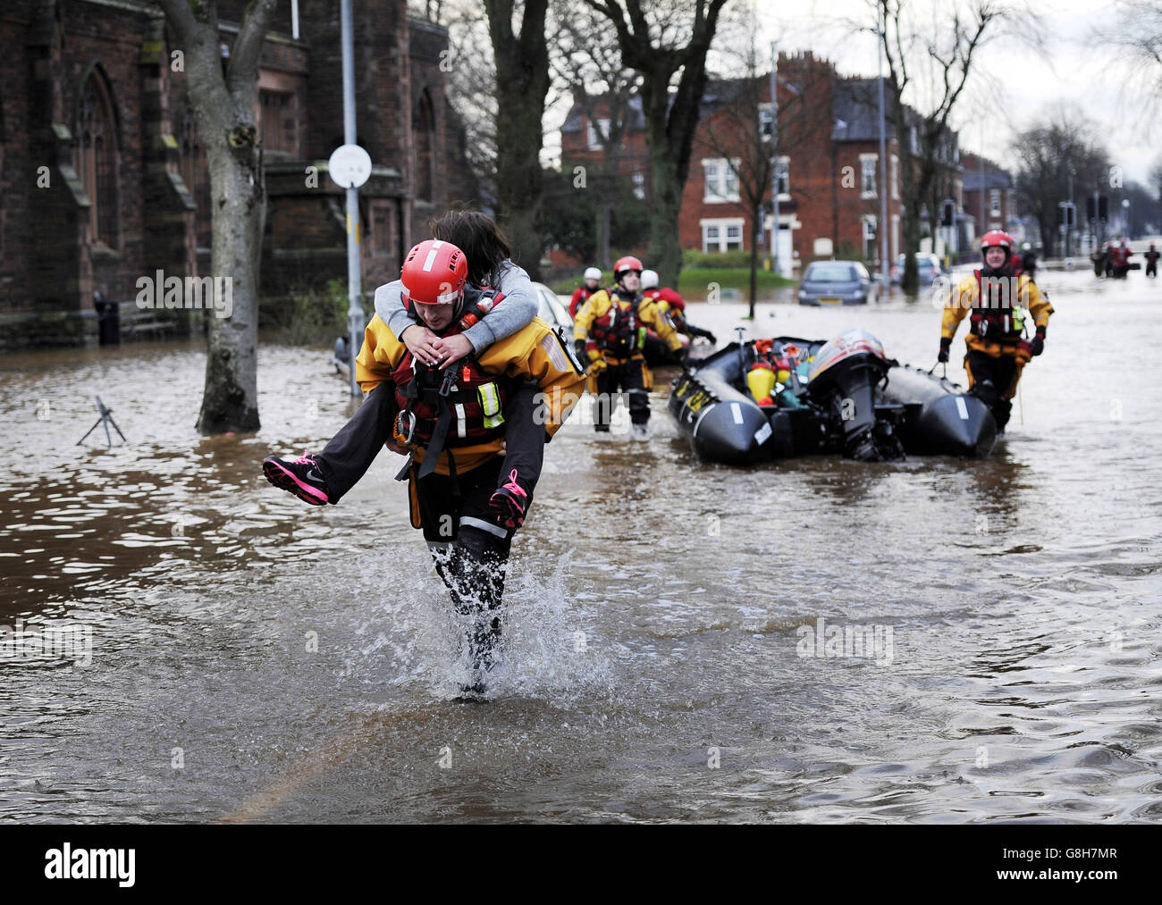 Fire and Rescue teams continue their work to bring people out of flooded homes in Carlisle following heavy rains over he weekend. Stock Photo