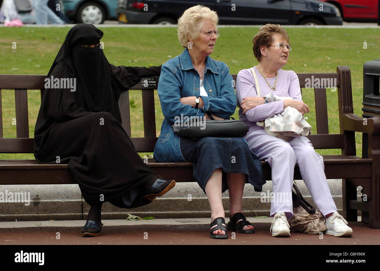 Three ladies share a bench in George Square Glasgow during a vigil for victims of the London bombings. The event, organised by the Muslim Association of Britain, the Stop the War Coalition and Scottish CND, also aim to underline public opposition to Islamophobic attacks carried out since the suspects first emerged. Stock Photo