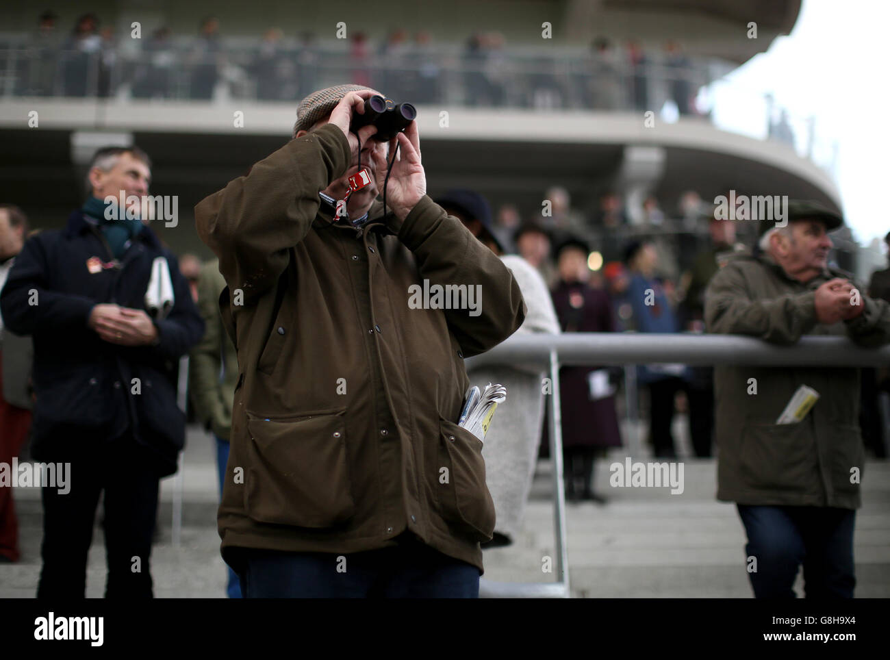 A racegoer in the stands during day one of The International at Cheltenham Racecourse. Stock Photo
