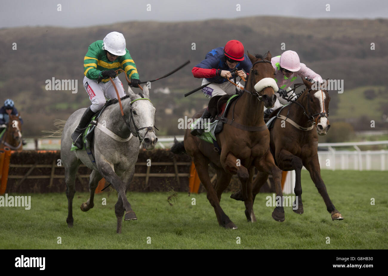 Old Guard ridden by Sam Twiston-Davies (centre) gets the better of Hagam ridden by Barry Geraghty (left) and Sempre Medici ridden by Ruby Walsh (right) before going on to win The StanJames.com International Hurdle Race run during day two of The International at Cheltenham Racecourse. Stock Photo