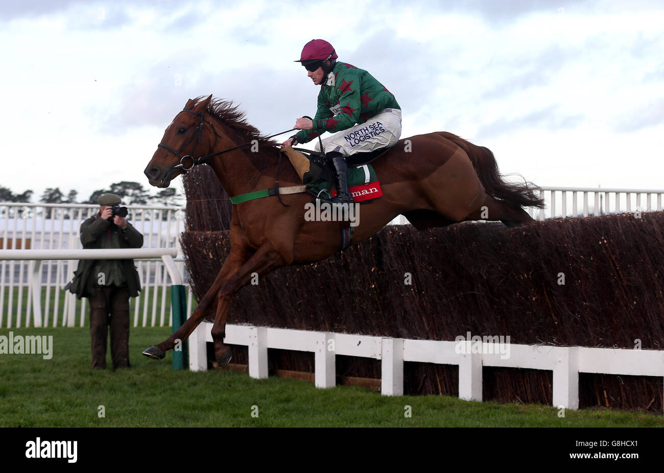 Knock House ridden by jockey Brian Hughes clear a fence during the Ryman Stationery Handicap Chase Stock Photo