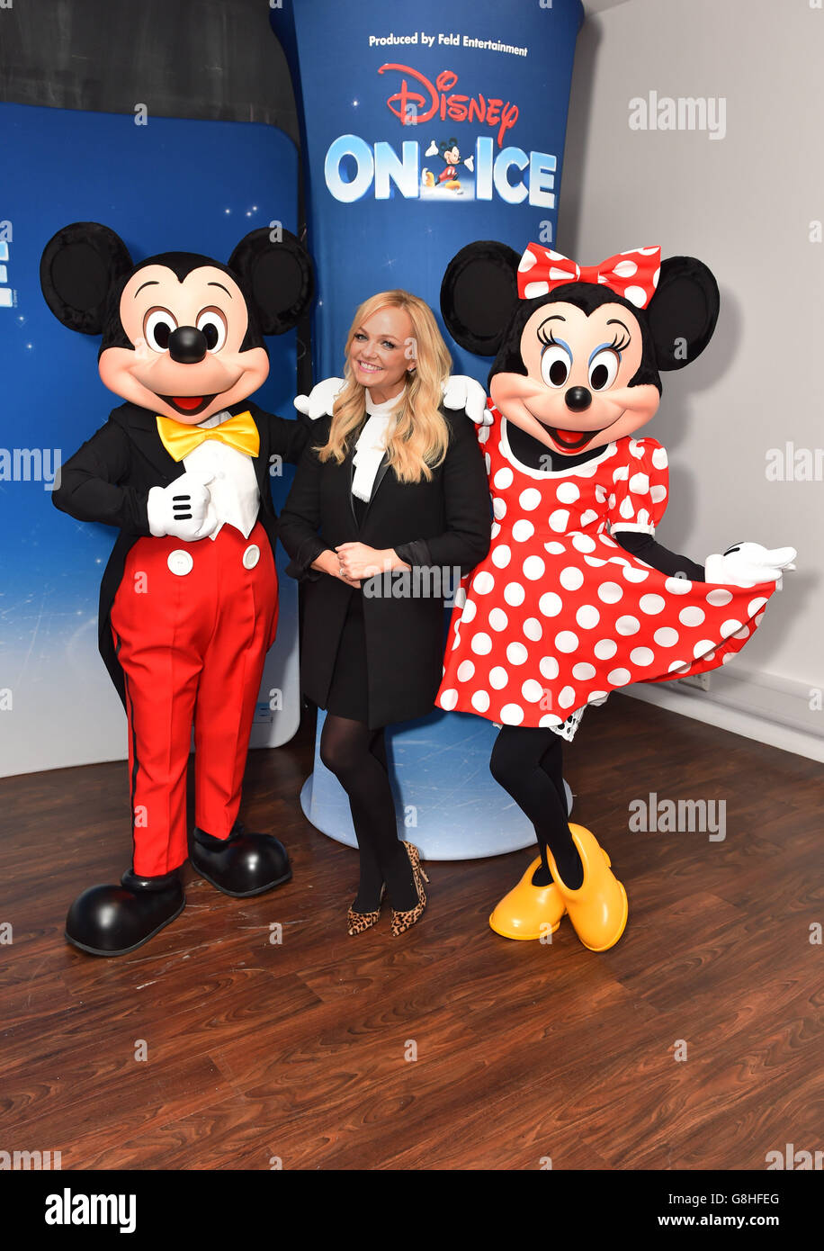Emma Bunton poses with Mickey and Minnie Mouse at the opening night of