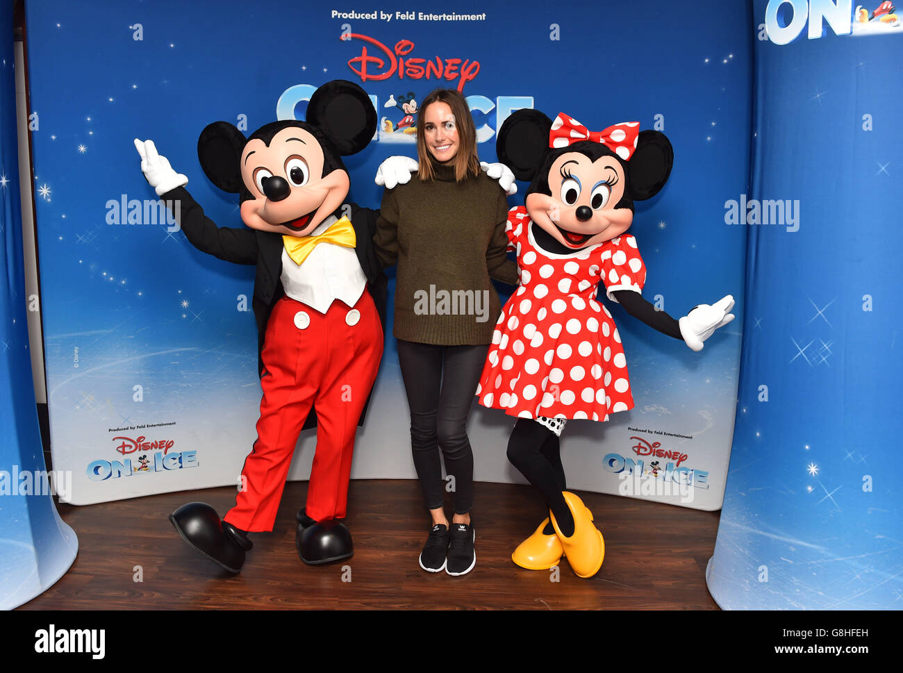Louise Roe poses with Mickey and Minnie Mouse at the opening night of Disney On Ice presents Worlds of Enchantment at the O2 Arena in London. Stock Photo