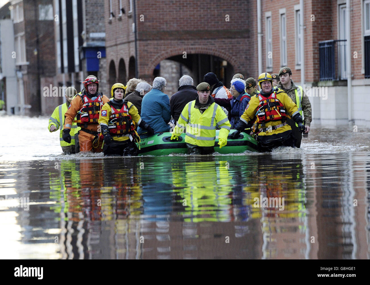 Members of the Army and rescue teams help evacuate people from flooded properties after they became trapped by rising floodwater when the River Ouse bursts its banks in York city centre. Stock Photo